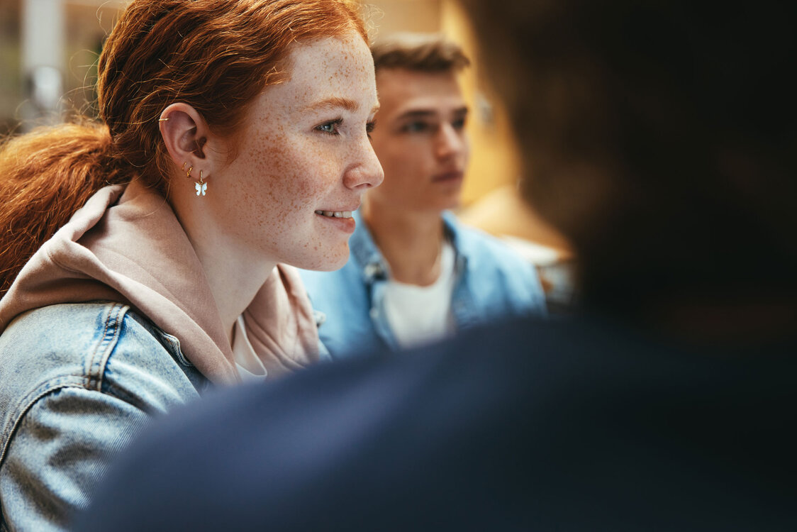 © ©Jacob Lund - stock.adobe.com Cheerful girl studying with friends in library | © ©Jacob Lund - stock.adobe.com